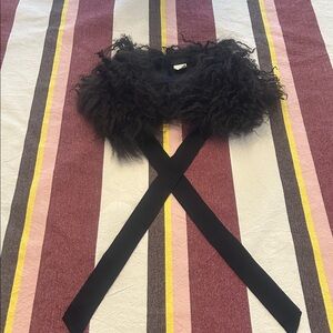 A Mongolian lamb neck cover in bittersweet chocolate brown 

One size